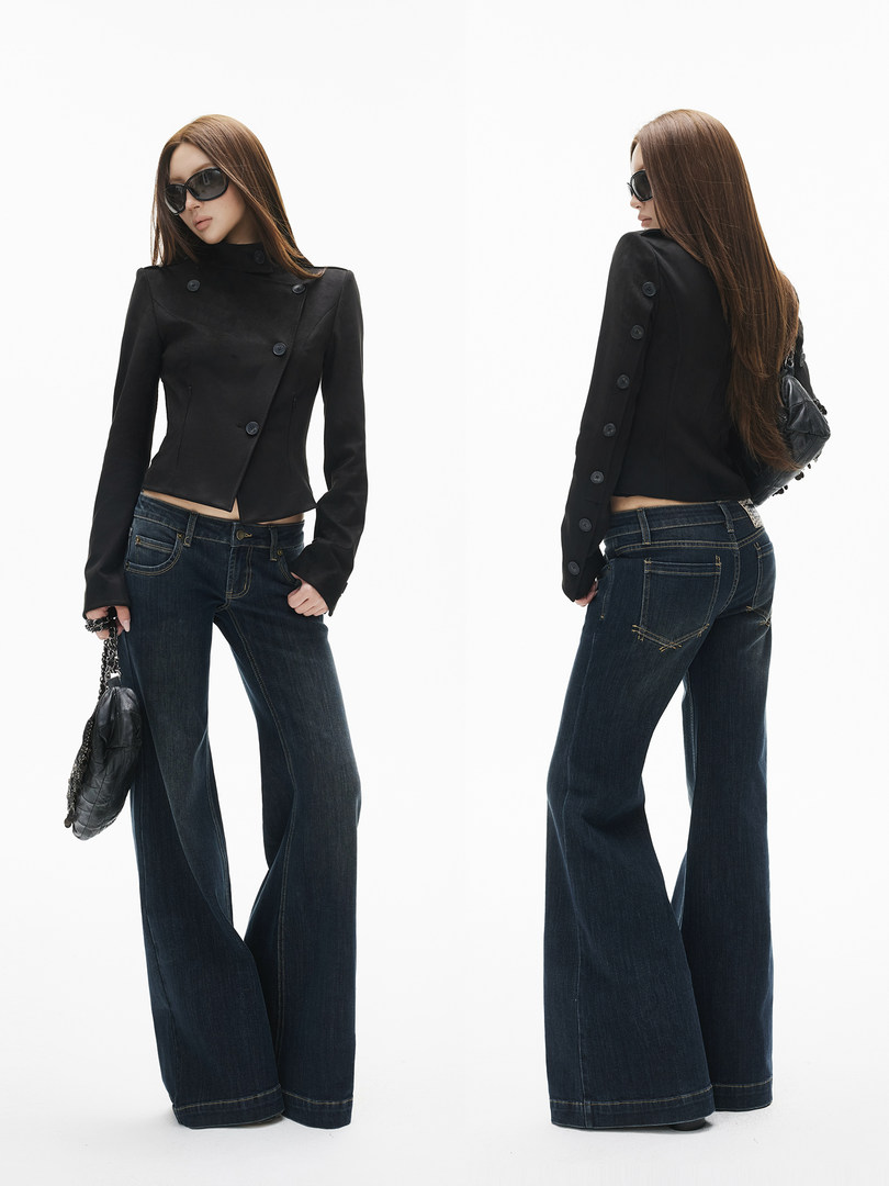 Model wearing a black fitted jacket with wide-leg dark jeans