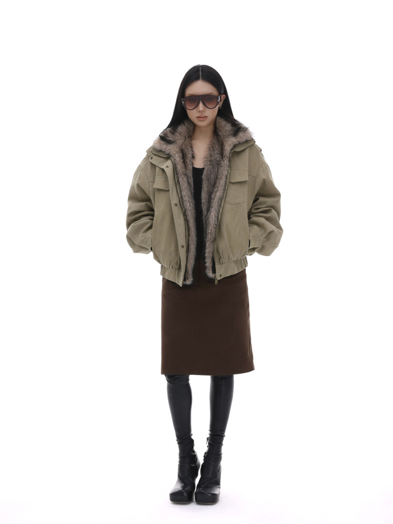 Model wearing an olive fur-lined winter jacket with black boots
