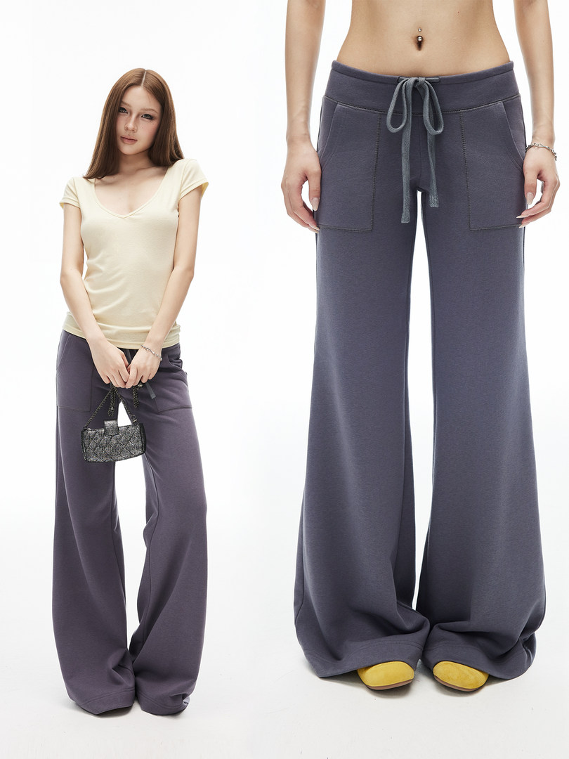 Model wearing gray wide-leg drawstring pants