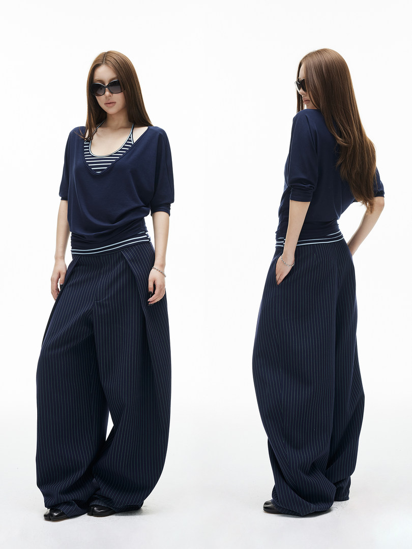 Navy pinstripe wide-leg pants and matching top worn by a model