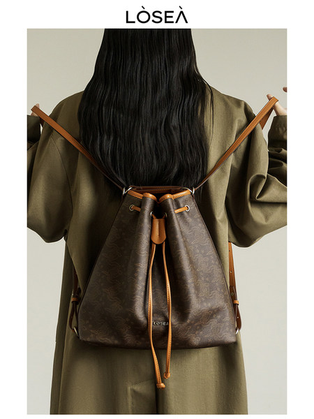 Brown drawstring backpack worn on a model