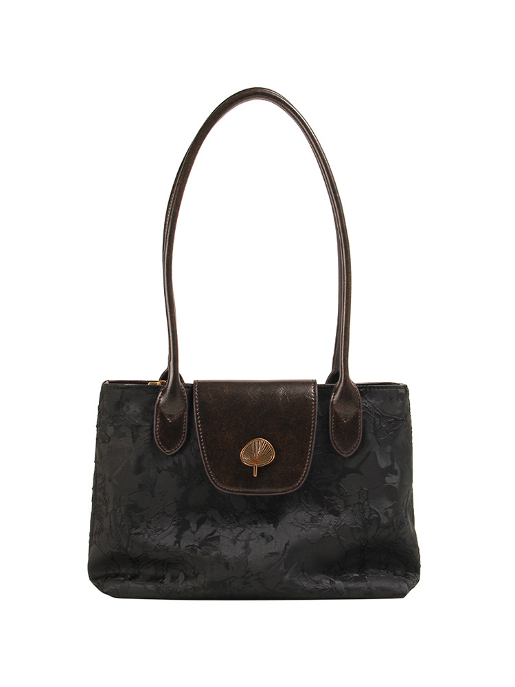 Black leather handbag with long shoulder straps on a white background