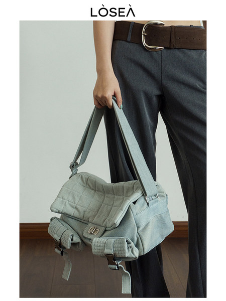 Light blue quilted shoulder bag worn by a model