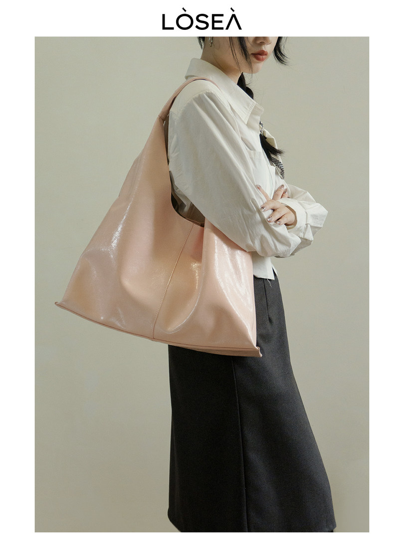 Woman carrying a large blush pink tote bag