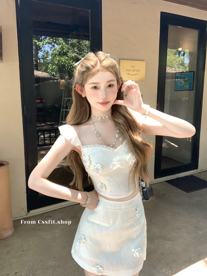 White floral two-piece outfit worn by a model outdoors