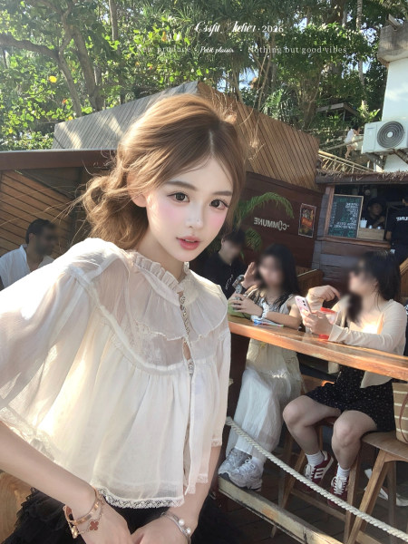 Woman wearing a sheer white ruffled blouse outdoors