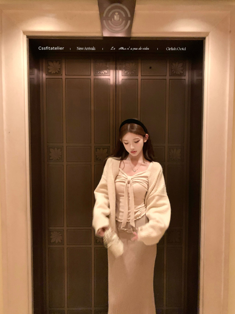 Woman wearing a cream knit cardigan and matching dress