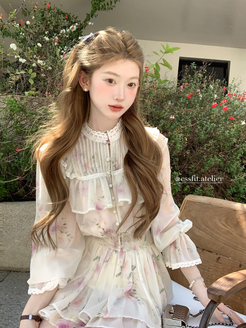 Woman wearing a sheer floral dress with lace details outdoors