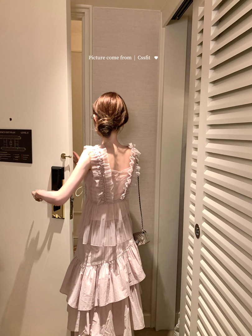 Woman wearing a pale pink ruffled tiered dress
