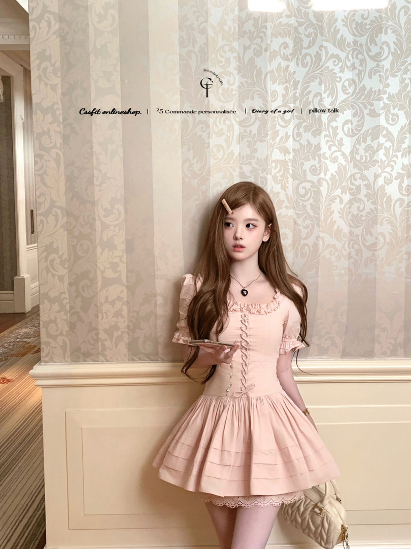 Pink feminine short dress worn by a model indoors