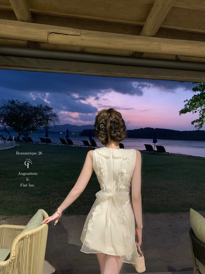 Cream lace sleeveless dress worn by a model outdoors at sunset