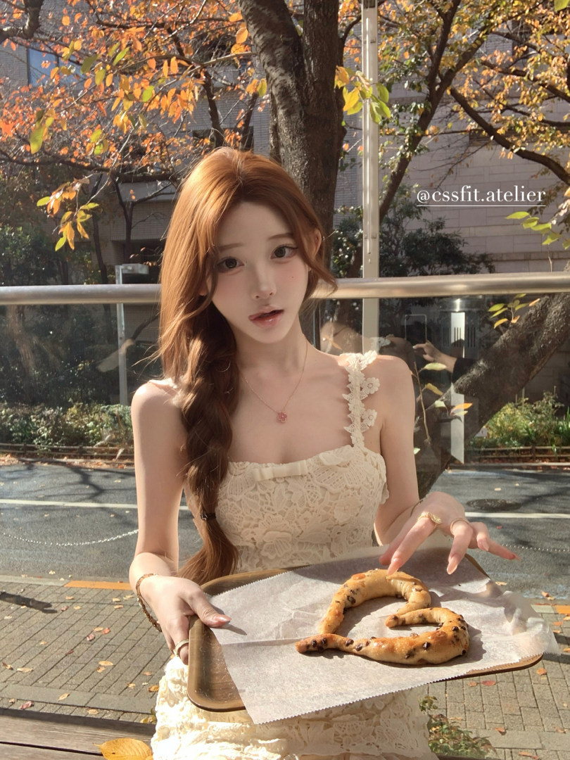 Cream lace sleeveless dress worn outdoors