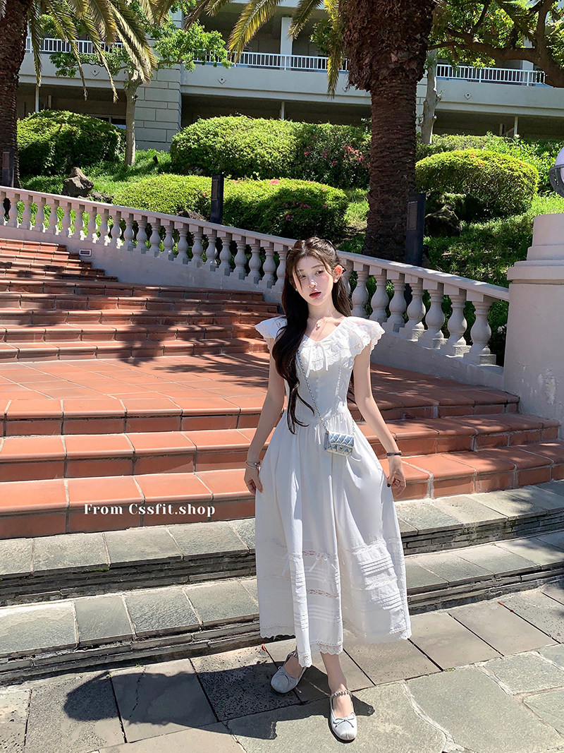 Woman wearing a white ruffled dress outdoors
