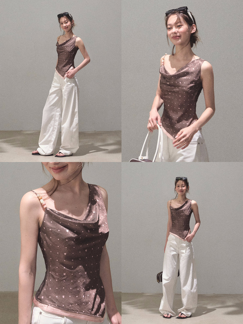 Model wearing a brown cowl-neck sleeveless top with white wide-leg pants