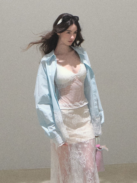 Model wearing a sheer lace lingerie dress with a light blue shirt