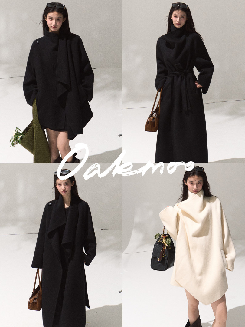 Model wearing an oversized draped coat in black and cream