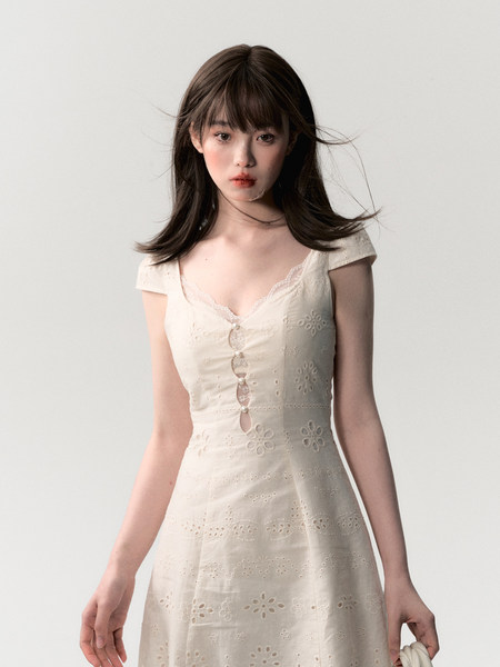 Cream embroidered dress worn by a model