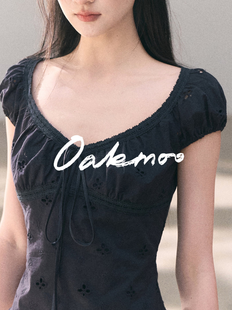 Black short-sleeve dress worn by a model