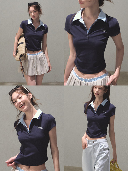 Model wearing a navy short-sleeve polo shirt with a light collar and casual trousers