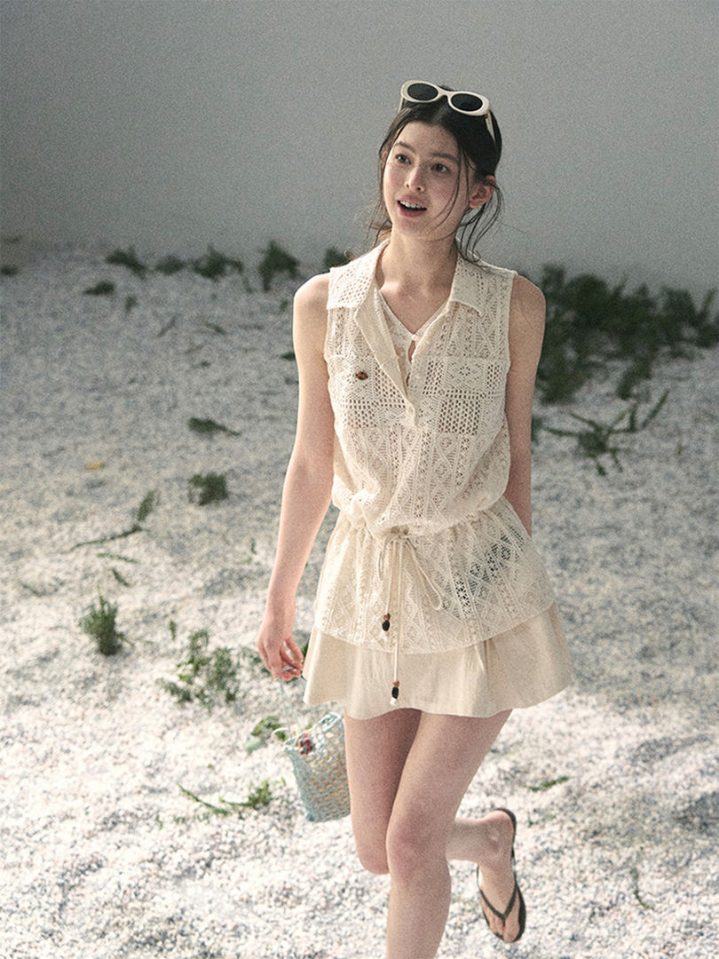 Woman wearing a white lace sleeveless beach outfit