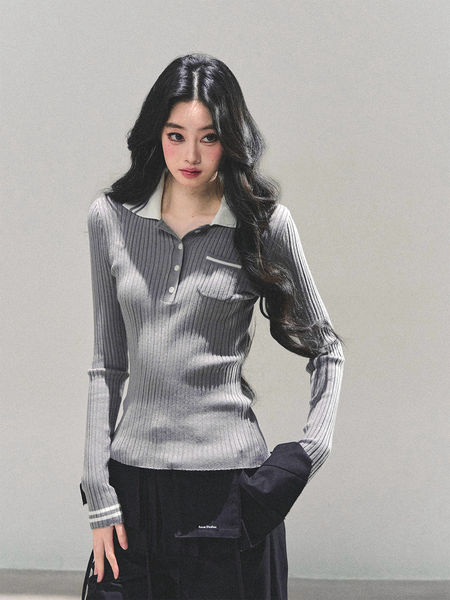 Model wearing a gray ribbed long-sleeve polo top