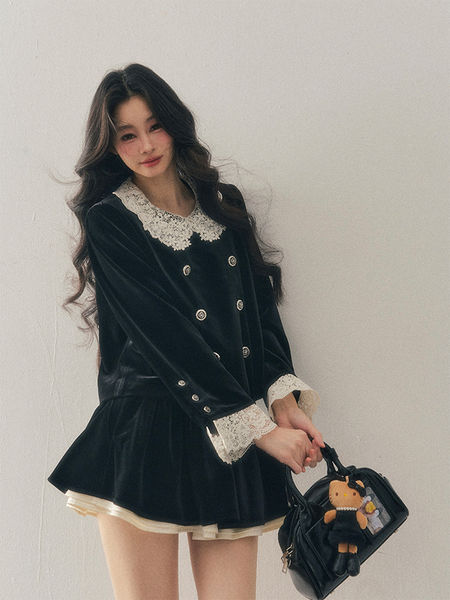Black velvet long-sleeve dress with white lace collar and cuffs worn by a model