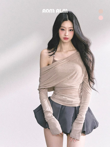 Model wearing a beige off-shoulder long-sleeve top with a gray mini skirt