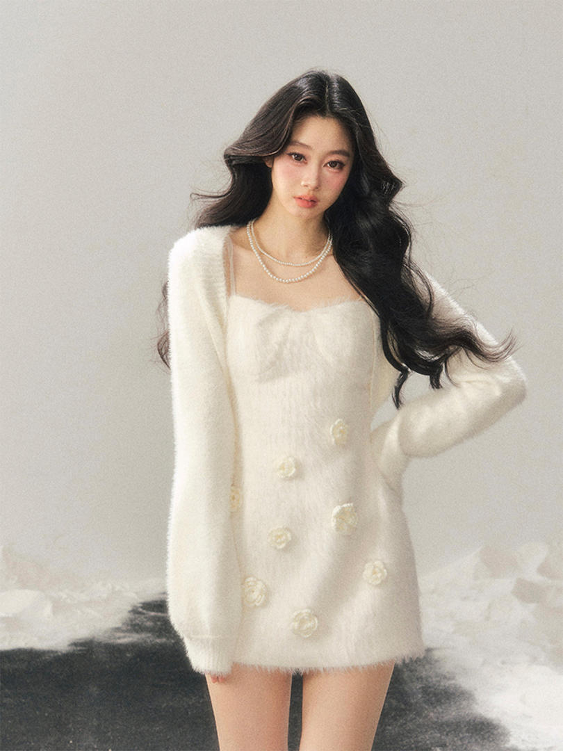 White fuzzy long-sleeve mini dress with pearl button details worn by a model