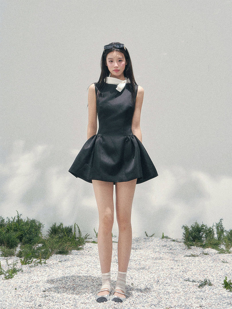 Black sleeveless mini dress worn by a model