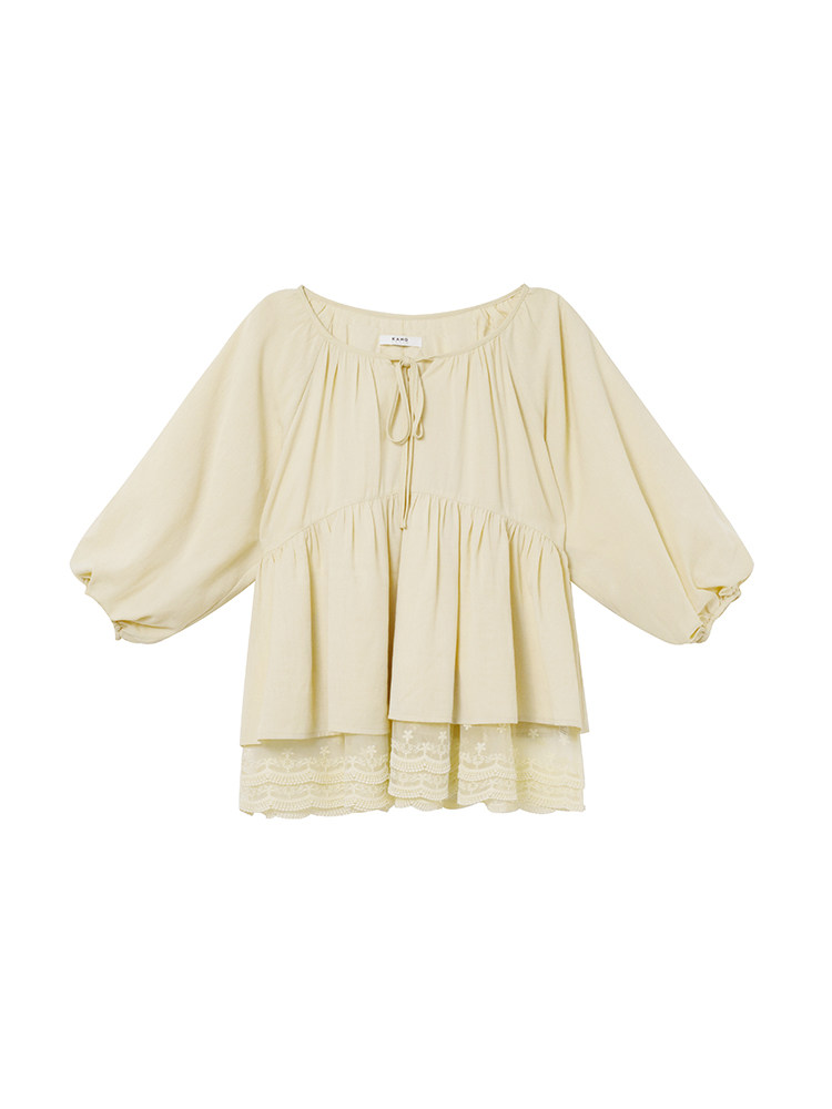 Cream peasant blouse with long puff sleeves and lace hem on a white background