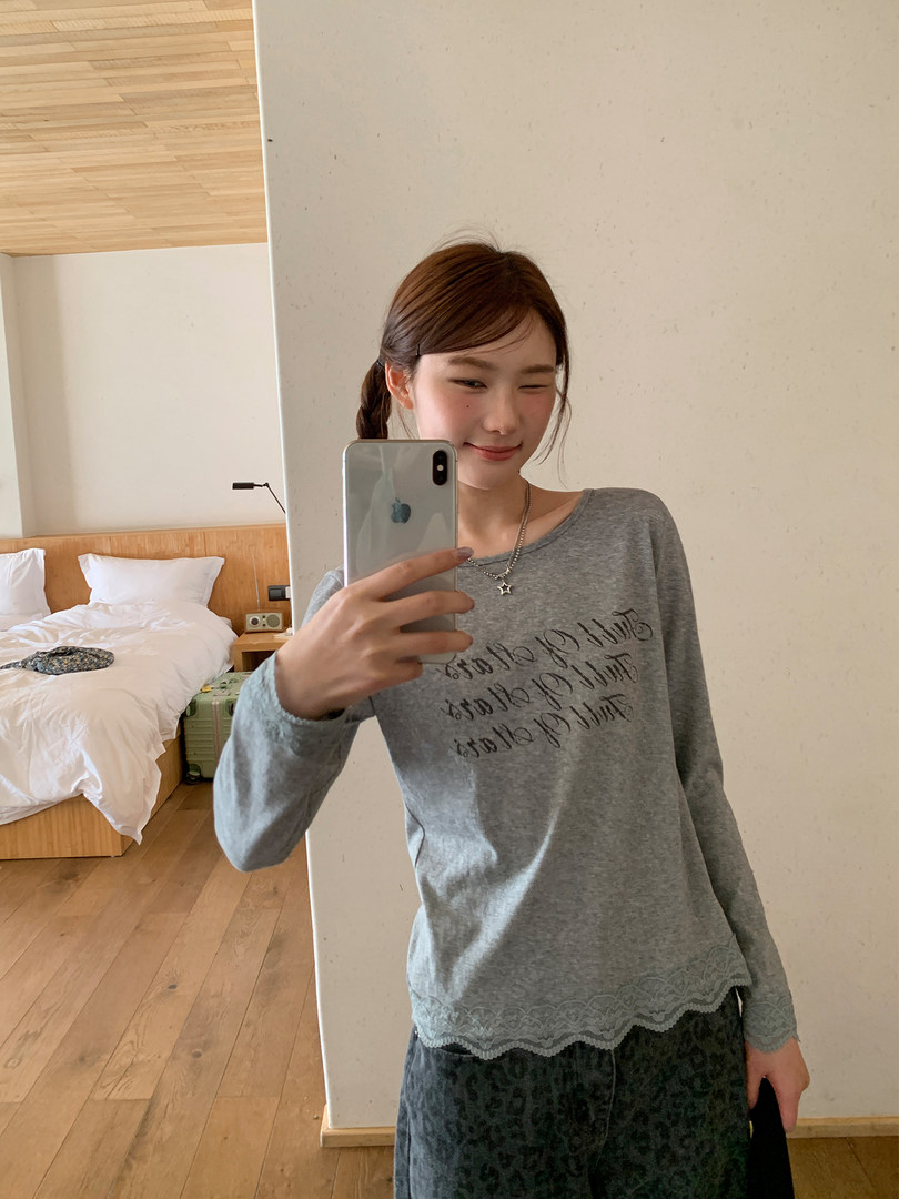 Gray long-sleeve top worn in a mirror selfie