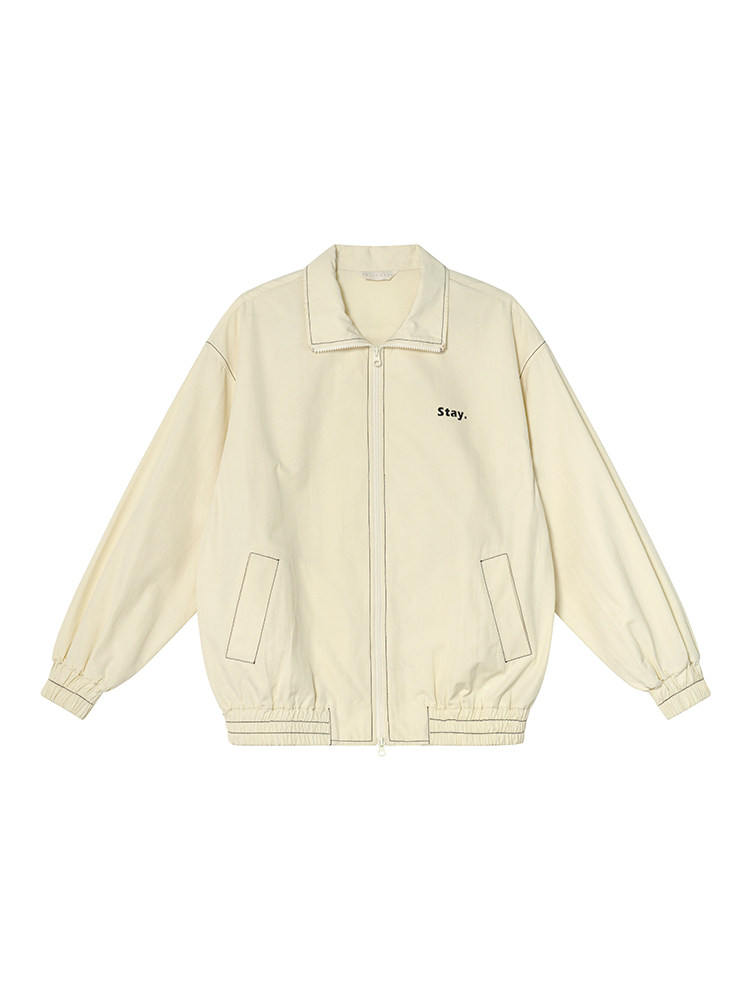 Cream zip-up jacket with front pockets and "Stay." text on white background