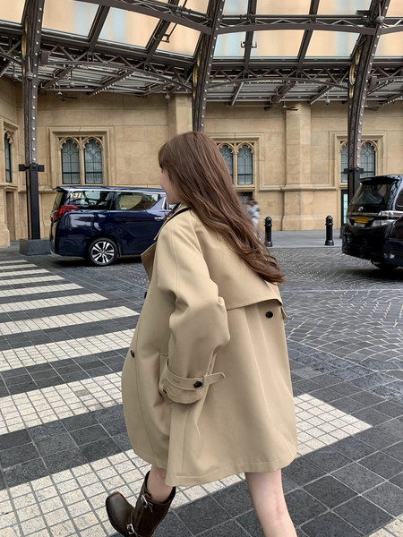 Beige trench coat worn by a woman outdoors