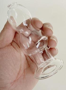 A self-pleasuring toy made of glass for use inside the anus.