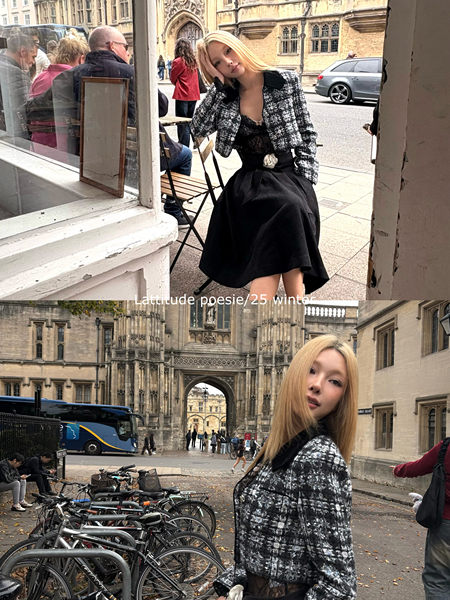 Model wearing a black-and-white tweed jacket with a black skirt in an outdoor street setting