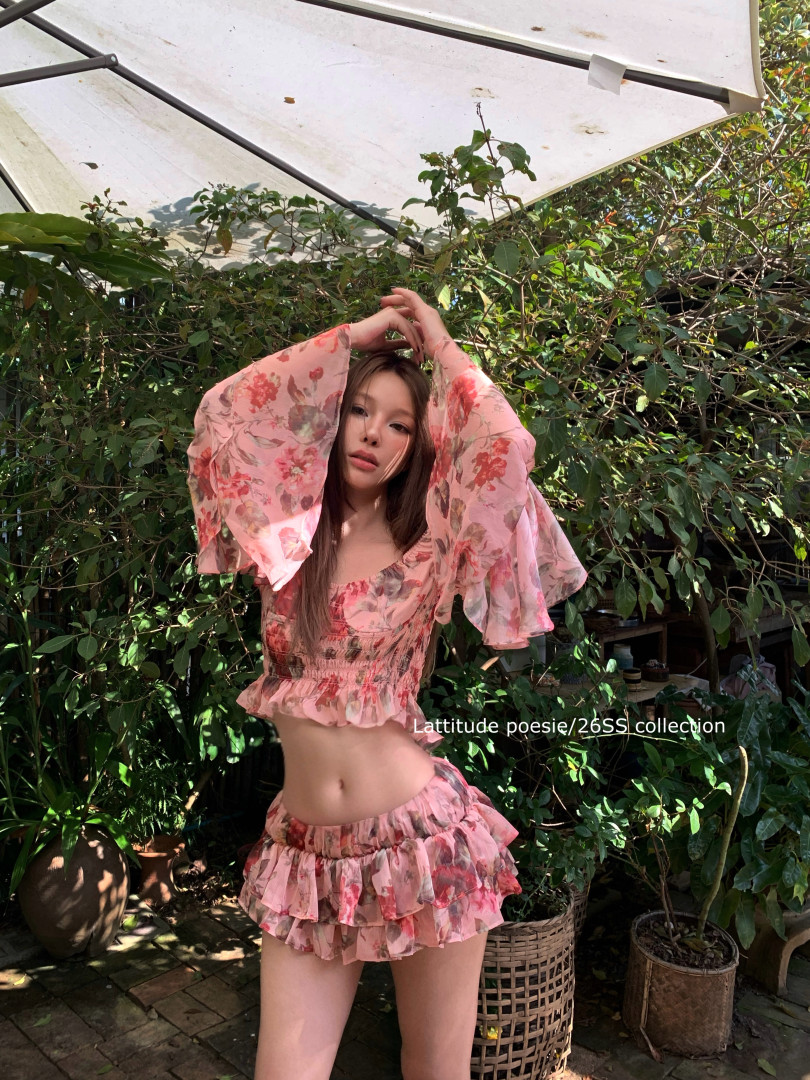 Floral pink two-piece outfit worn by a model outdoors