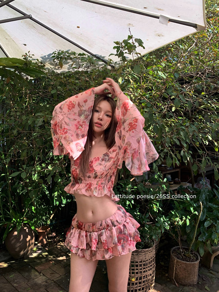 Floral pink two-piece outfit worn by a model outdoors