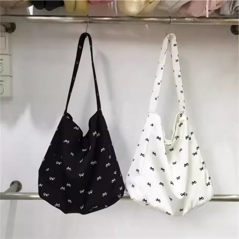 韩版单肩可折叠蝴蝶结帆布包女小众托特包购物袋设计2025新款时尚