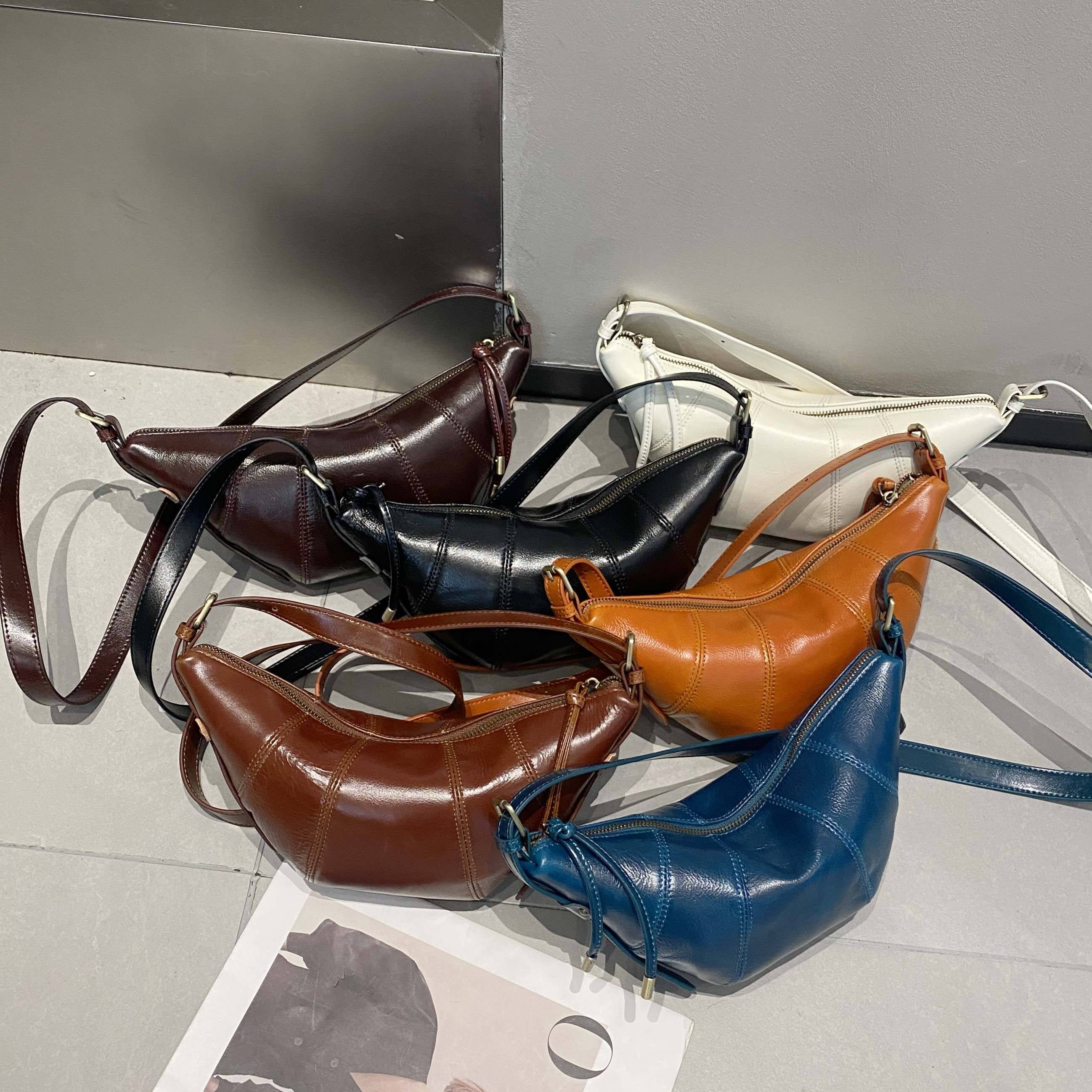 新品真皮女包韩版百搭时尚头层油蜡牛皮潮女单肩斜跨牛角包饺子包