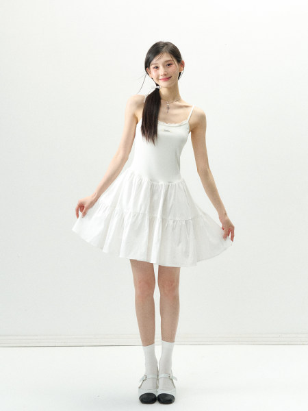 White sleeveless mini dress worn by a model on a plain background