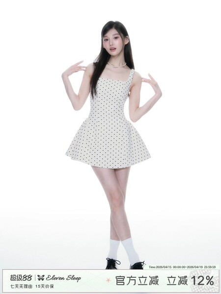 Young woman wearing a white polka dot sleeveless mini dress