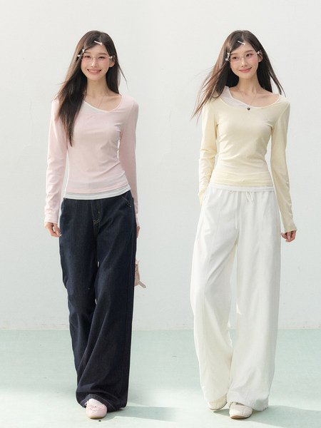 Two models wearing pastel long-sleeve tops with loose pants