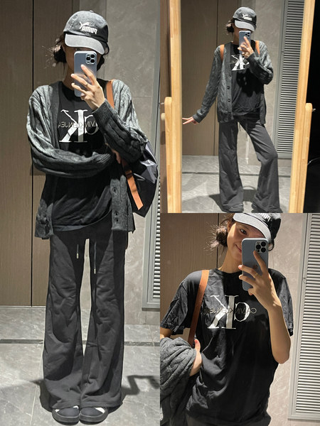 Person wearing a black casual streetwear outfit in mirror selfies