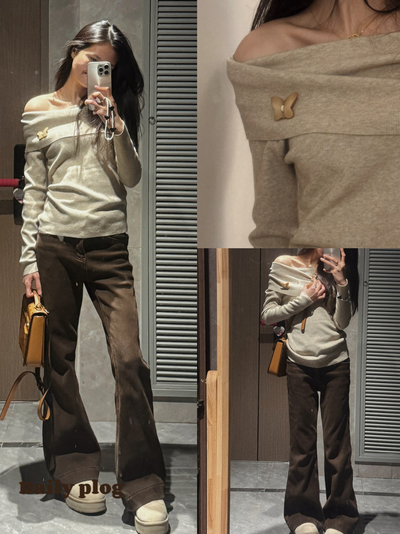 Model wearing an off-shoulder knit top with dark flared pants and a small handbag