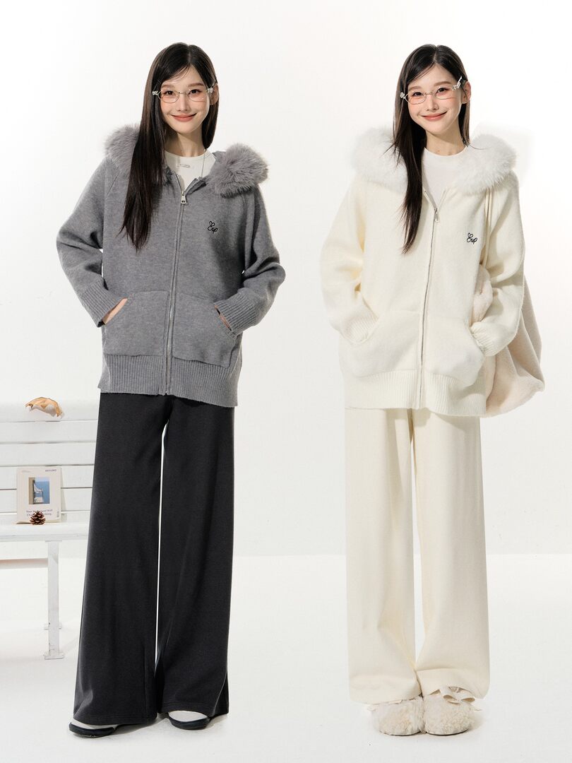 Model wearing a cozy zip-up knit cardigan set in gray and cream with wide-leg pants