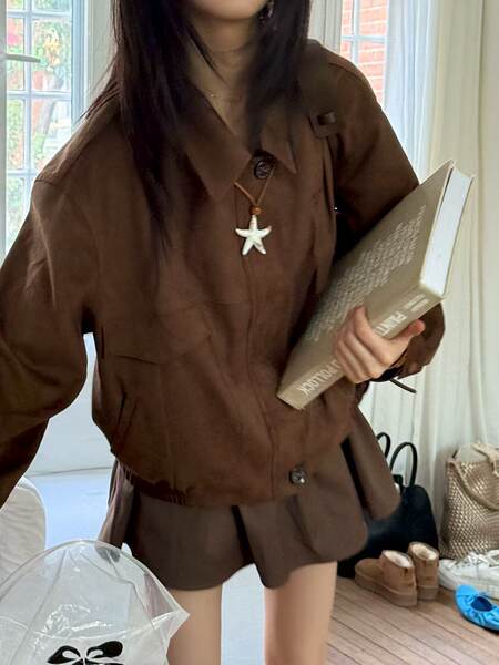 Brown two-piece outfit worn by a model indoors