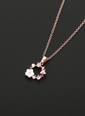 Fashioned with a flower shelled pearl necklace and a sweet b