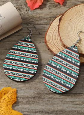 The Omegas Aztec wooden earrings stamped with water-shaped