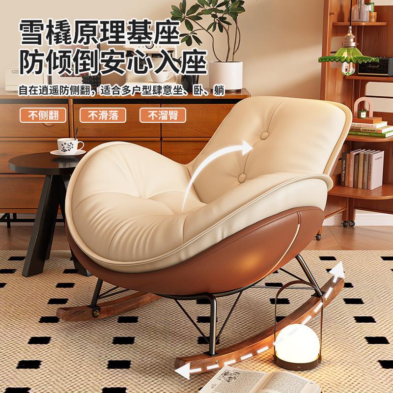 A rocking chair and a grown-up can sleep in a bed with a laz