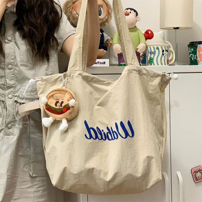 松弛感托特包包女2025新款抽绳帆布包通勤轻便手提袋大容量单肩包